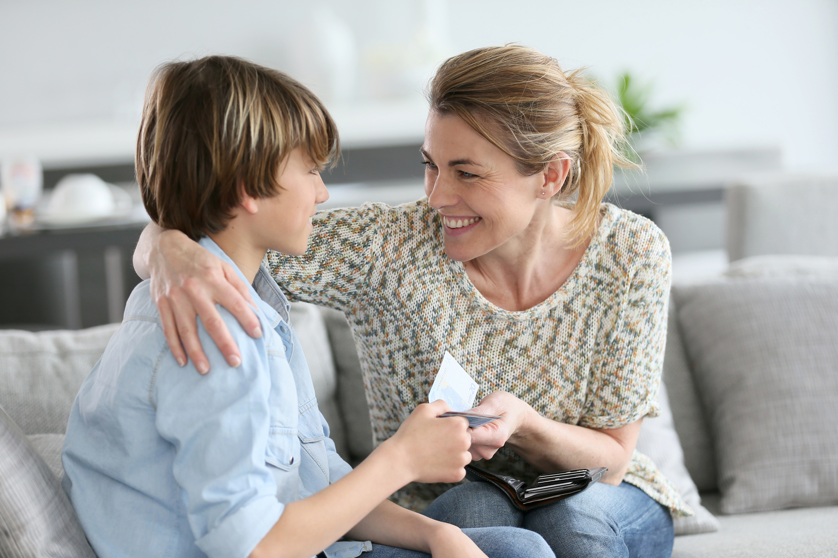 Parent and child talking together about money
